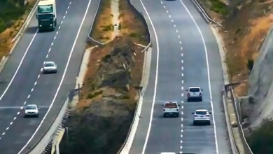 a couple of cars driving down a highway
