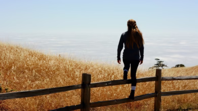 woman jump on brown fence