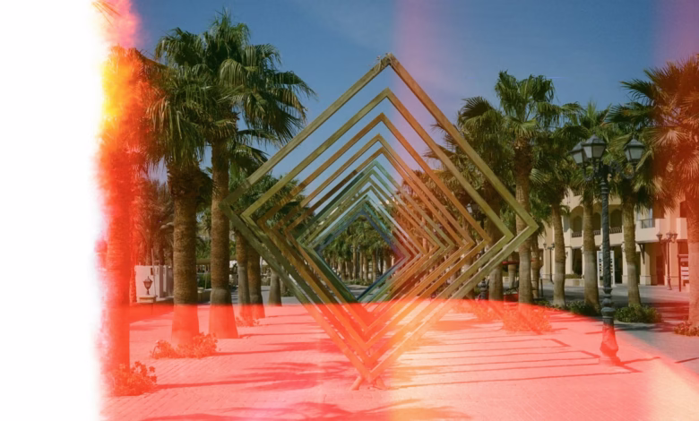 Palm trees line a walkway with geometric art.