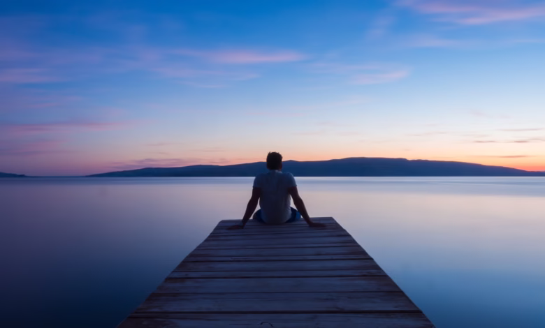 man siting on wooden dock