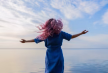 woman in blue shirt standing on water during daytime