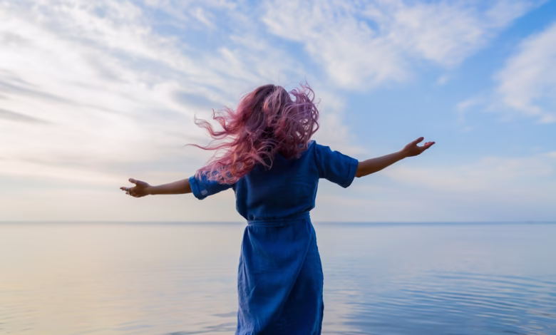 woman in blue shirt standing on water during daytime
