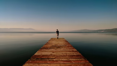 person on dock near body of water