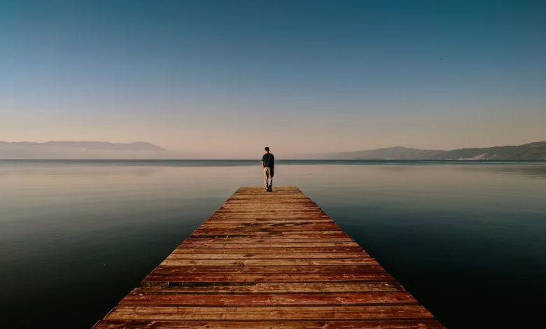 person on dock near body of water