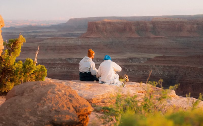 Two people admire the canyon's view.