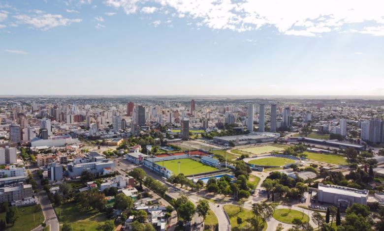 an aerial view of a city with a soccer field