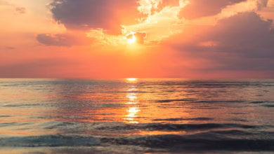 sea under white clouds at golden hour