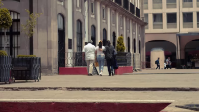 a group of people walking on a sidewalk