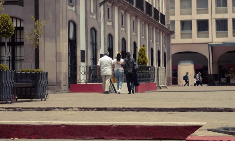 a group of people walking on a sidewalk