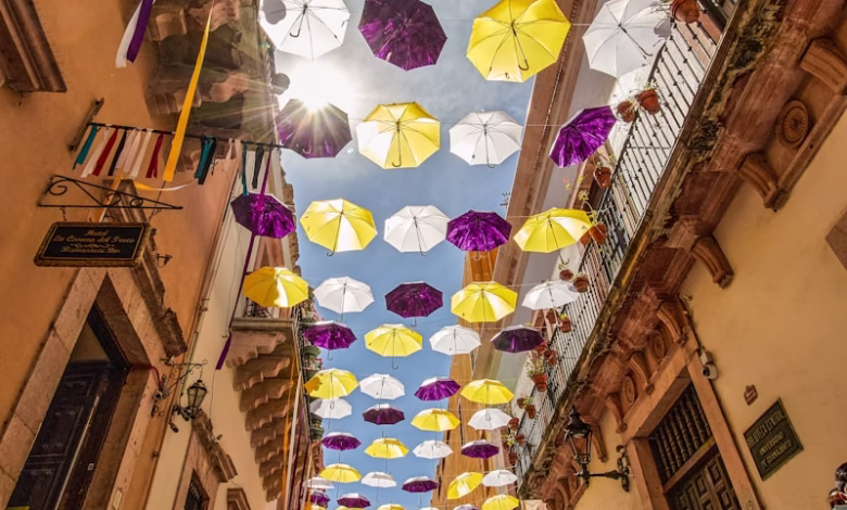 pink and white umbrella hanging on the street