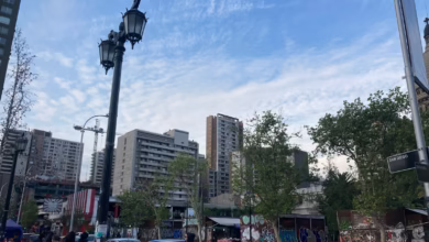 a city street with cars and people