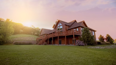 brown wooden house with green grass field