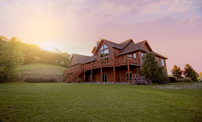 brown wooden house with green grass field