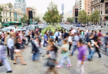 timelapse photo of people passing the street