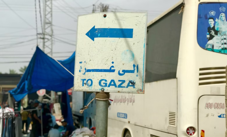 a white bus parked next to a blue and white sign