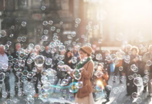 woman standing outdoor surrounded by bobbles during daytime