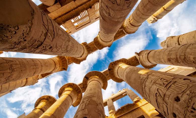 low angle photography of brown concrete building under blue sky during daytime