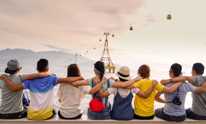 people holding shoulders sitting on wall