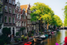 Canal houses and boats in amsterdam on a sunny day