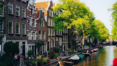 Canal houses and boats in amsterdam on a sunny day