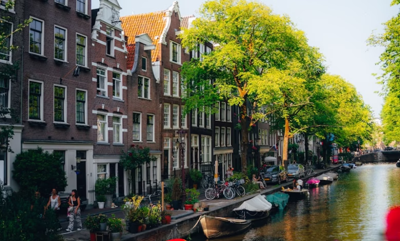 Canal houses and boats in amsterdam on a sunny day
