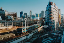 A train travels through a bustling city.