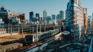 A train travels through a bustling city.