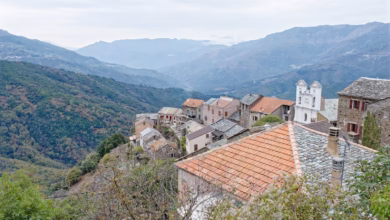 Hillside village with old buildings and mountains