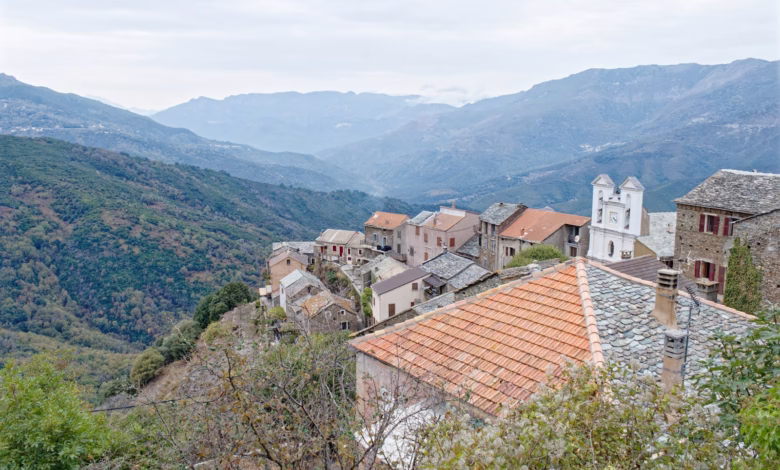 Hillside village with old buildings and mountains