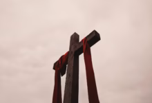 low angle view of cross with red garment