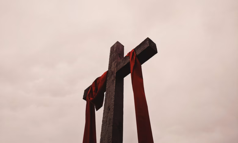 low angle view of cross with red garment