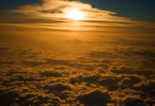 the sun is shining through the clouds in the sky