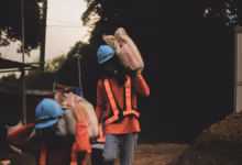 a group of people walking down a dirt road
