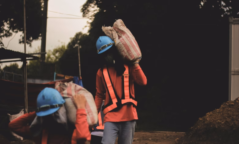 a group of people walking down a dirt road