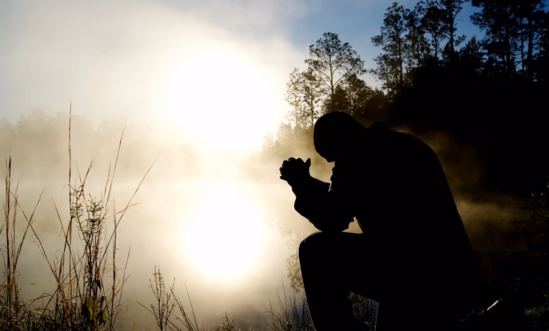 silhouette of kneeling man