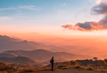 man standing on hill digital wallpaper