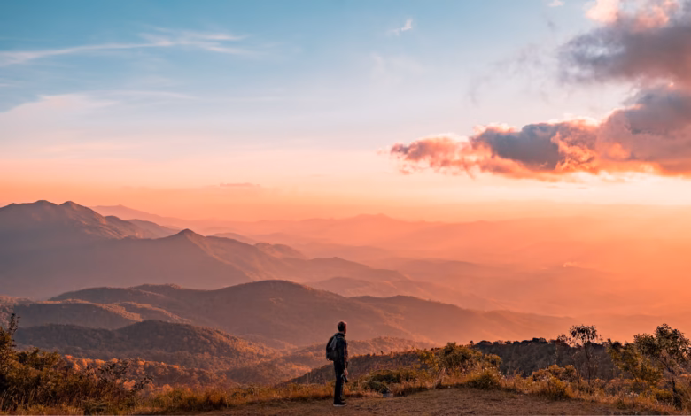 man standing on hill digital wallpaper