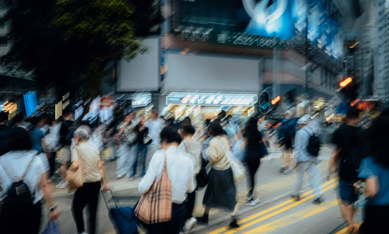 Dynamic urban scene with blurred pedestrians crossing a busy street.