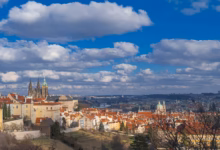 Breathtaking panorama of Prague featuring St. Vitus Cathedral and classic architecture under a vibrant sky.