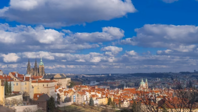 Breathtaking panorama of Prague featuring St. Vitus Cathedral and classic architecture under a vibrant sky.