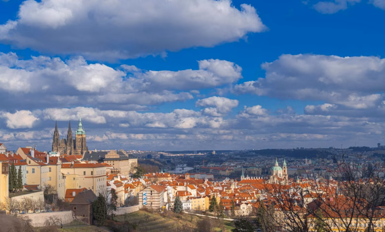 Breathtaking panorama of Prague featuring St. Vitus Cathedral and classic architecture under a vibrant sky.