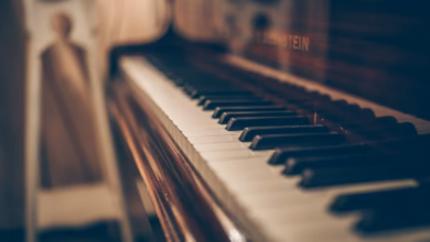 a close up of a piano with a person in the background