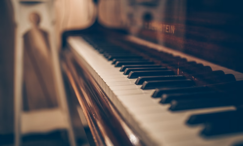 a close up of a piano with a person in the background