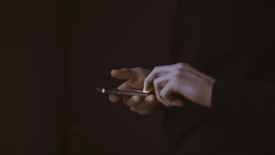 silhouette photo of person holding smartphone