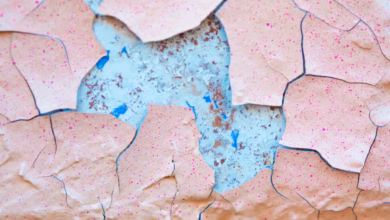 A close up of a piece of paper with paint peeling off of it