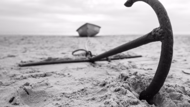 a broken umbrella sitting on top of a sandy beach