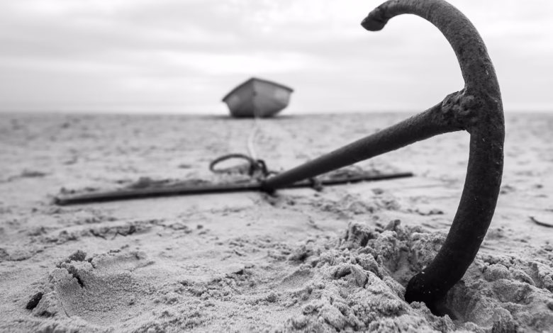 a broken umbrella sitting on top of a sandy beach