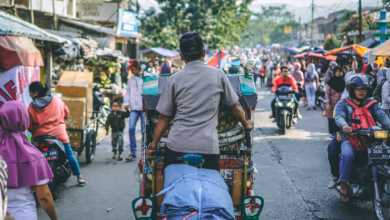 selective photography of man pedaling wagon