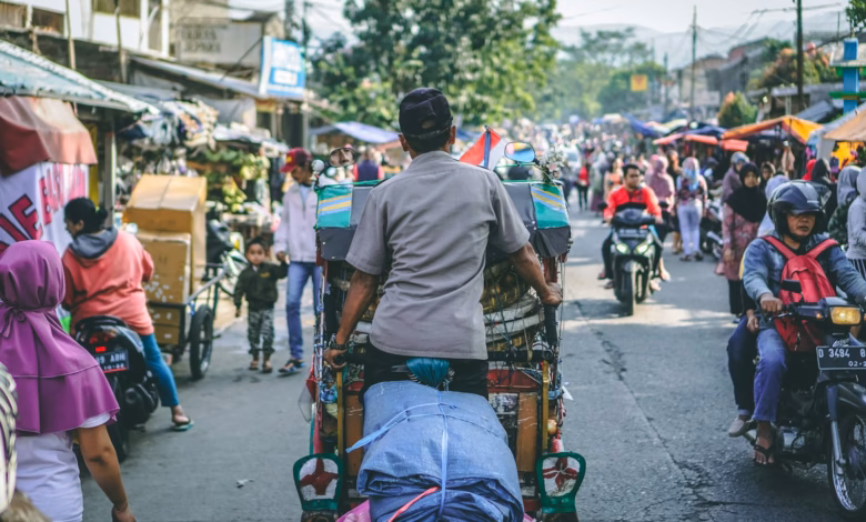 selective photography of man pedaling wagon