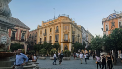 group of people walking near beige structure